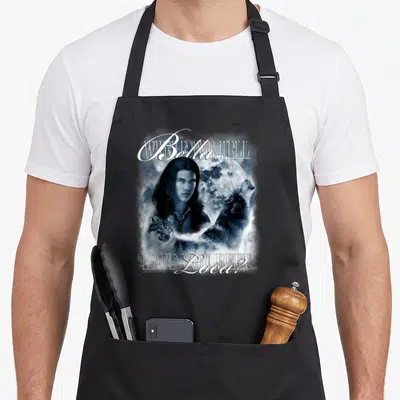 Jacob love swan apron - Man face full moon two wolves blue grey text Where THE HELL Bella HAVE YOU BEEN Loca — shown on a black cotton canvas apron against a white background