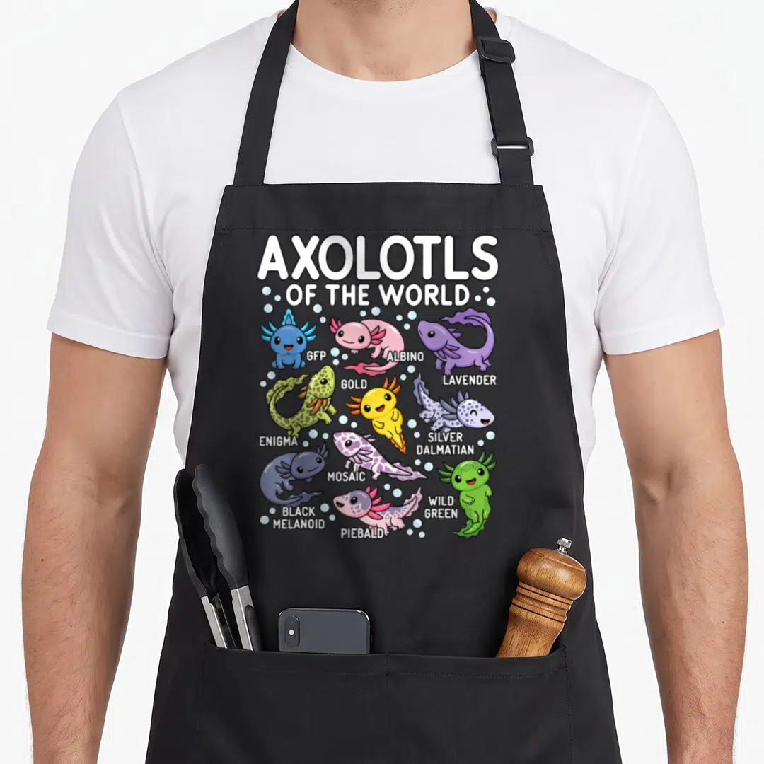 Cute axolotl kawaii apron - Nine cartoon axolotls labeled GFP, Albino, Lavender, Gold, Enigma, Silver Dalmatian, Black — shown on a black cotton canvas apron against a white background