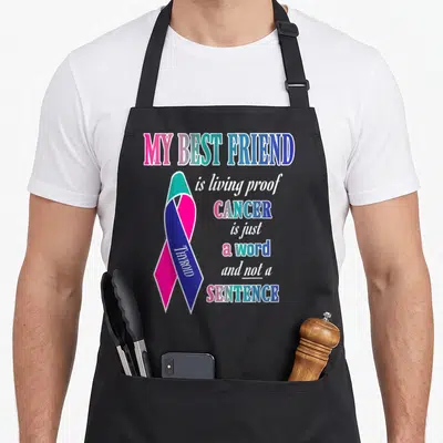 Thyroid friends apron - Pink teal blue white ribbon with vertical Thyroid text and stacked awareness quote — shown on a black cotton canvas apron against a white background