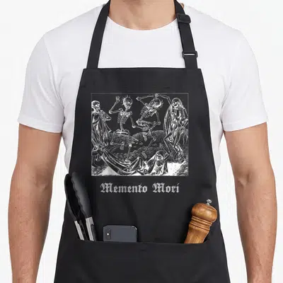 Memento world music apron - White line-art of four dancing skeletons in a frame above gothic Memento Mori text — shown on a black cotton canvas apron against a white background