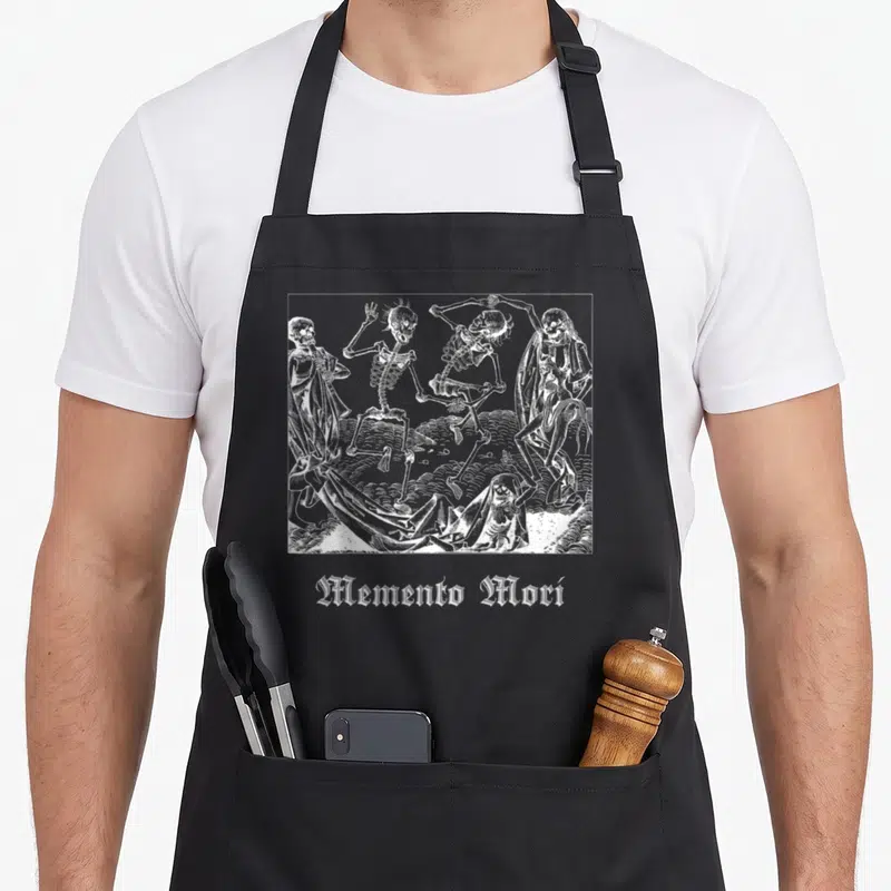 Memento world music apron - White line-art of four dancing skeletons in a frame above gothic Memento Mori text — shown on a black cotton canvas apron against a white background