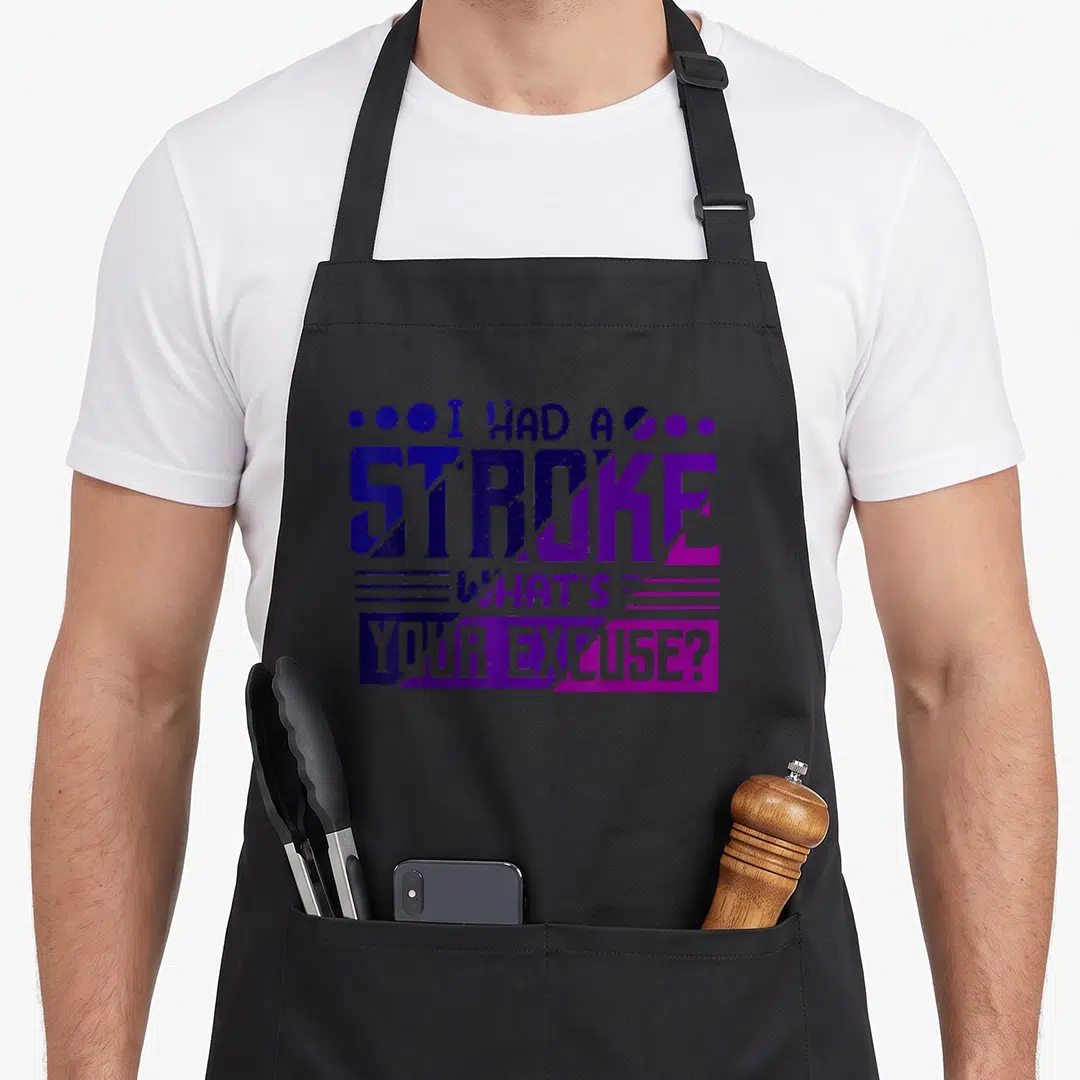 Funny excuse stroke awareness apron - Stacked text I HAD A STROKE WHAT'S YOUR EXCUSE? in blue purple magenta — shown on a black cotton canvas apron against a white background