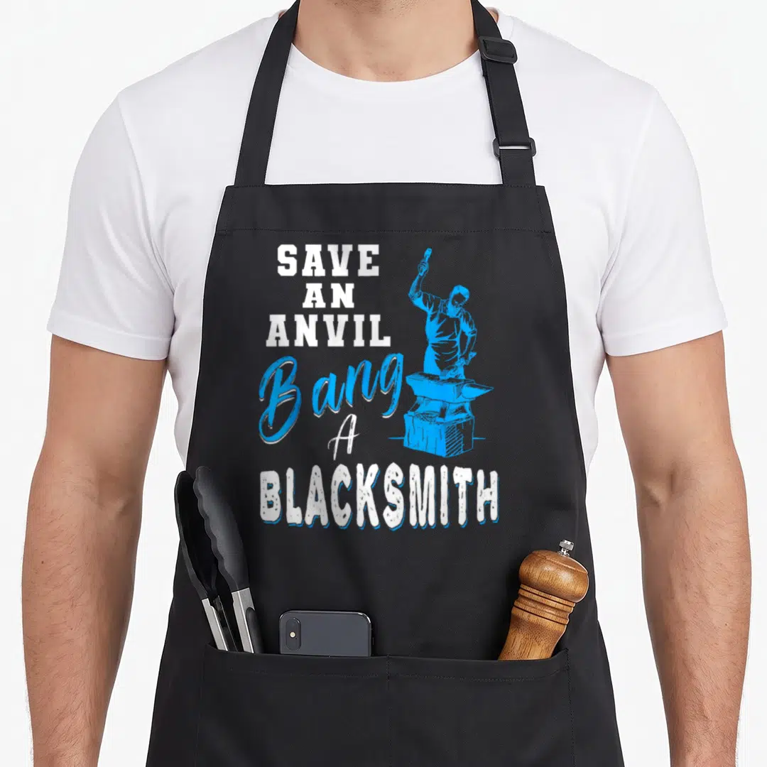 Save blacksmith apron - Blue cartoon smith standing over anvil with white and blue text Save An Anvil Bang A Blacksmith — shown on a black cotton canvas apron against a white background