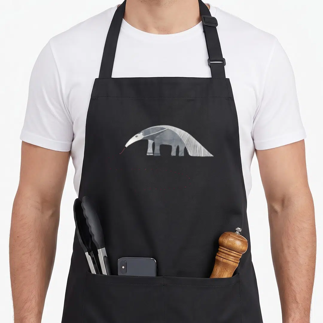 Nicsquirrell animal apron - Stylized anteater with red dotted line in grey, white, blue, and red — shown on a black cotton canvas apron against a white background