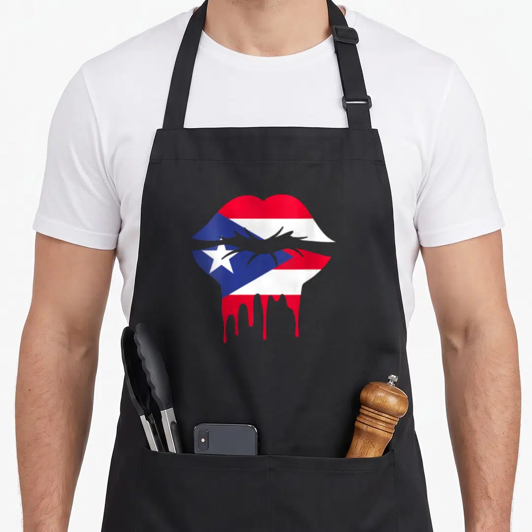 Flag rican pride apron - Pair of lips filled with red, white, and blue flag pattern with red drips falling below — shown on a black cotton canvas apron against a white background