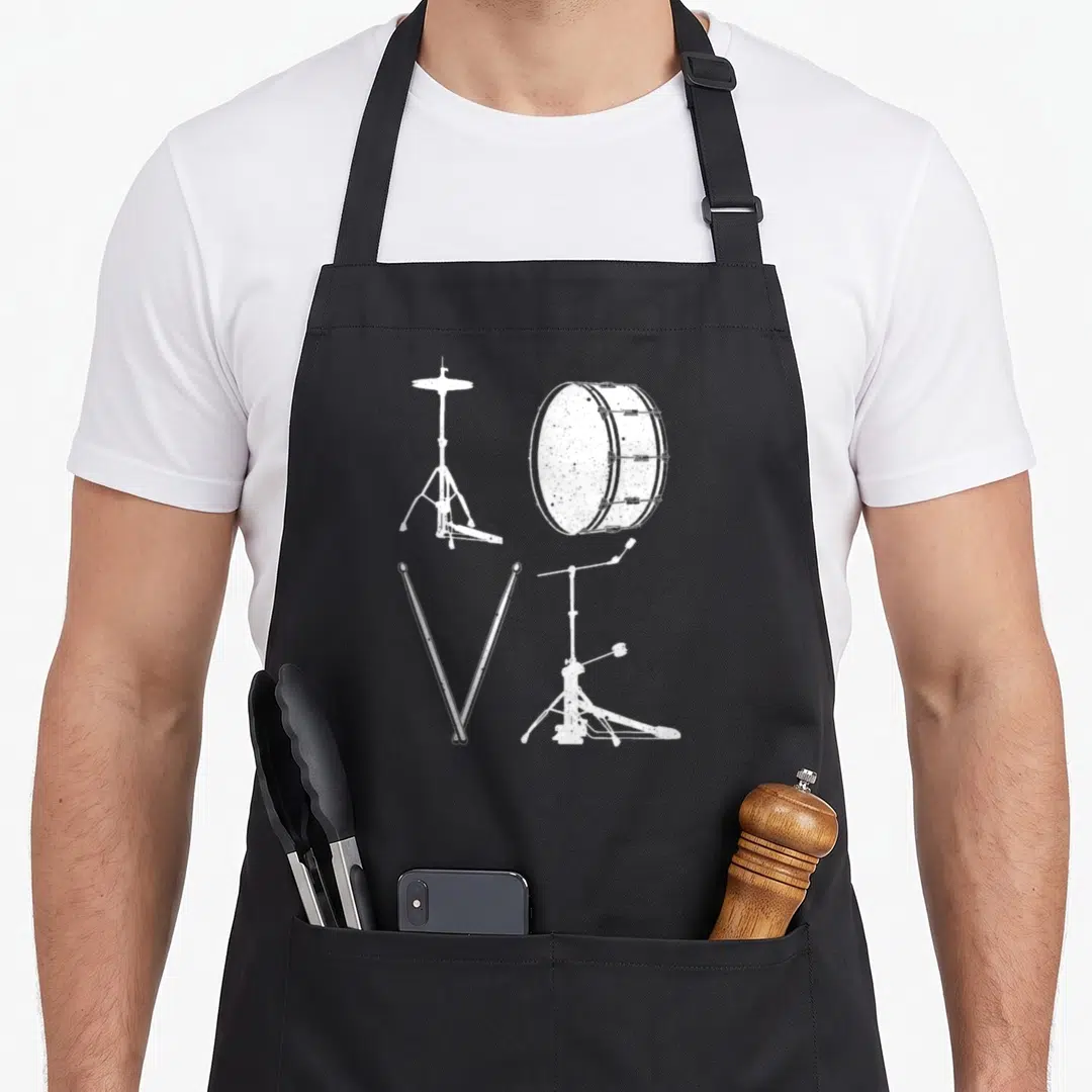 Drumming drums apron - White distressed drum kit parts arranged to visually spell the word LOVE — shown on a black cotton canvas apron against a white background