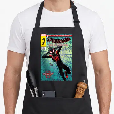 Collector crew apron - Spider-Man leaning against web on comic cover with Marvel logo and pricing box — shown on a black cotton canvas apron against a white background