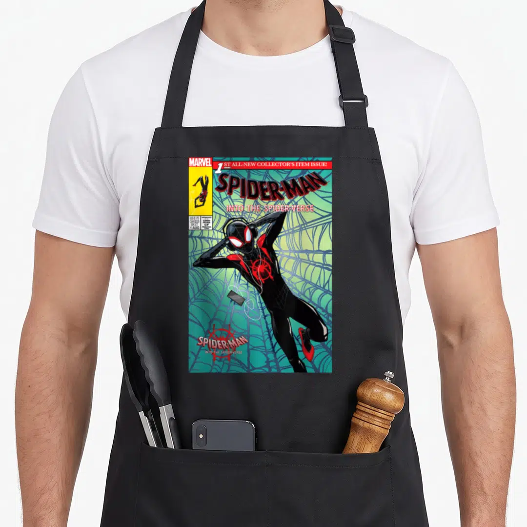 Collector crew apron - Spider-Man leaning against web on comic cover with Marvel logo and pricing box — shown on a black cotton canvas apron against a white background