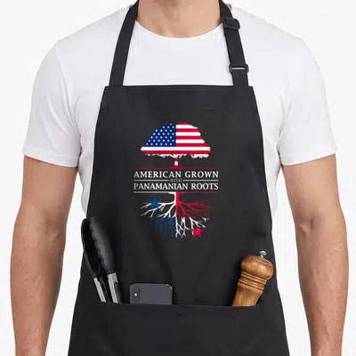 Grown panamanian apron - Tree with US flag canopy and Panama flag roots split by American Grown with Panamanian Roots — shown on a black cotton canvas apron against a white background