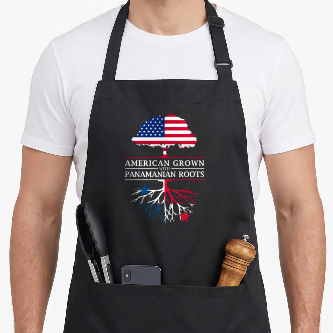 Grown panamanian apron - Tree with US flag canopy and Panama flag roots split by American Grown with Panamanian Roots — shown on a black cotton canvas apron against a white background