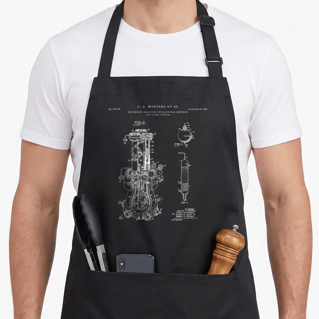 Patent nuclear apron - White line-art schematic of Neutronic Reactor Patent No 2545794 showing Figures 2 3 and 4 — shown on a black cotton canvas apron against a white background
