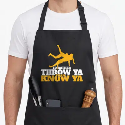 Rather wrestling apron - Yellow wrestler silhouette above stacked white and yellow text reading I'd Rather Throw Ya — shown on a black cotton canvas apron against a white background