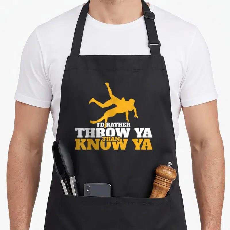 Rather wrestling apron - Yellow wrestler silhouette above stacked white and yellow text reading I'd Rather Throw Ya — shown on a black cotton canvas apron against a white background