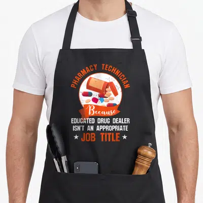 Pharmacy dealer apron - Pill bottle graphic with text Because Educated Drug Dealer Isn't An Appropriate Job Title — shown on a black cotton canvas apron against a white background