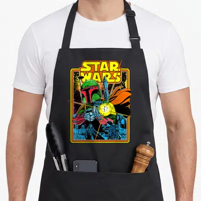 Comic hunter apron - Star Wars Boba Fett comic cover art in yellow green red blue orange — shown on a black cotton canvas apron against a white background