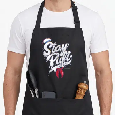 Marshmallow font stay puft apron - Melting white text Stay Puft with sailor hat and red necktie on canvas — shown on a black cotton canvas apron against a white background