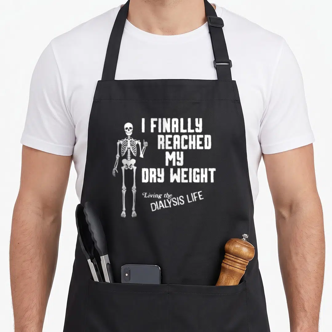Finally dry apron - White skeleton thumbs up next to I Finally Reached My Dry Weight text — shown on a black cotton canvas apron against a white background