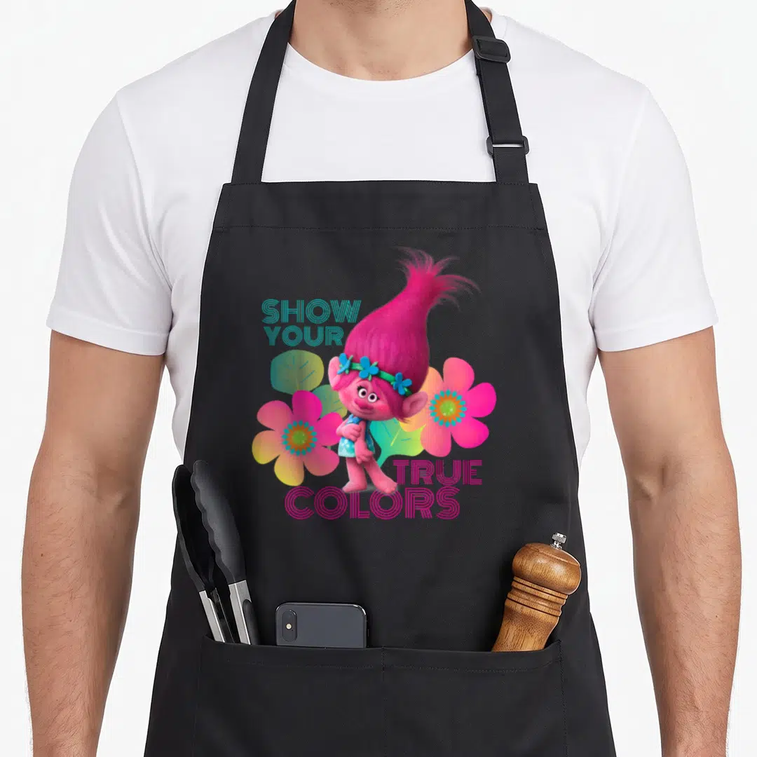Show troll apron - Pink cartoon character flanked by flowers with Show Your True Colors text — shown on a black cotton canvas apron against a white background