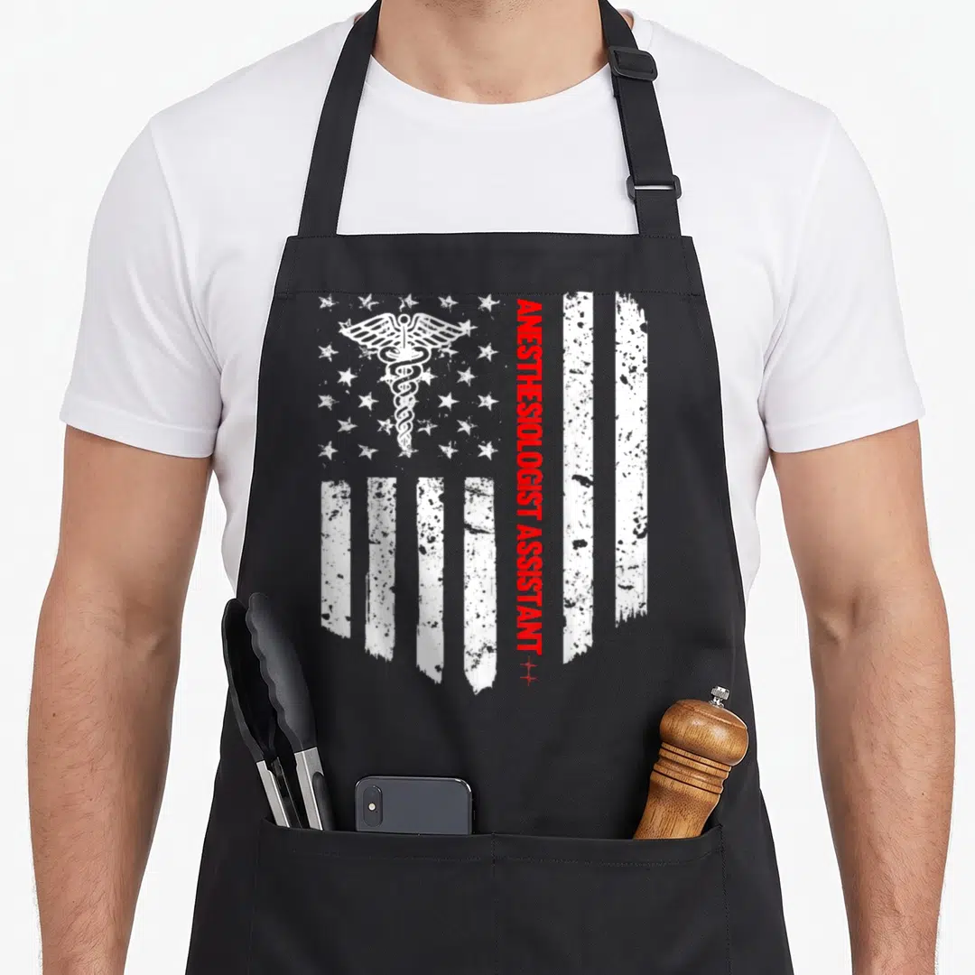 Anesthesiologist american flag apron - Distressed white caduceus over stars with vertical red ANESTHESIOLOGIST — shown on a black cotton canvas apron against a white background