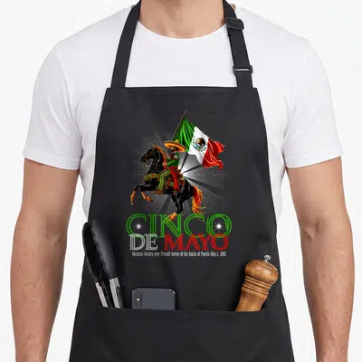 Battle mexican apron - Charro on rearing horse holding flag above Cinco De Mayo text and 1862 date — shown on a black cotton canvas apron against a white background