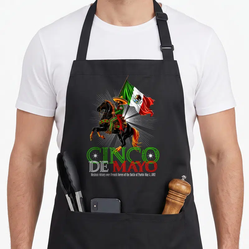 Battle mexican apron - Charro on rearing horse holding flag above Cinco De Mayo text and 1862 date — shown on a black cotton canvas apron against a white background