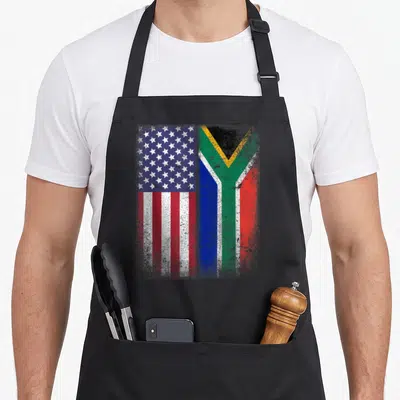 South mozambique apron - Two flags side-by-side: USA on left, South Africa on right, distressed red white blue green — shown on a black cotton canvas apron against a white background