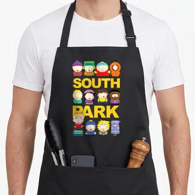 Jumbo south apron - Yellow SOUTH PARK text with twelve cartoon characters in yellow blue red green orange — shown on a black cotton canvas apron against a white background