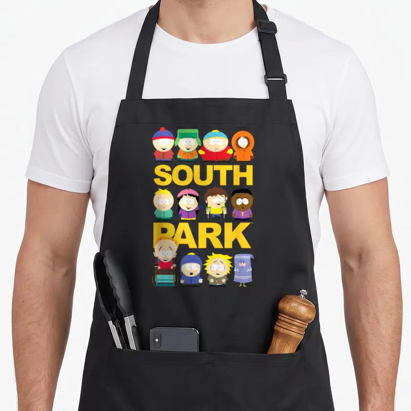 Jumbo south apron - Yellow SOUTH PARK text with twelve cartoon characters in yellow blue red green orange — shown on a black cotton canvas apron against a white background
