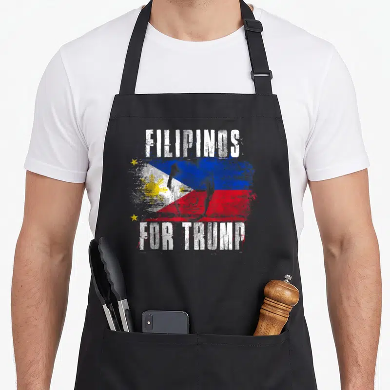 Filipino patriotic apron - Distressed FILIPINOS FOR TRUMP text over Philippine flag with Trump face overlay in white — shown on a black cotton canvas apron against a white background