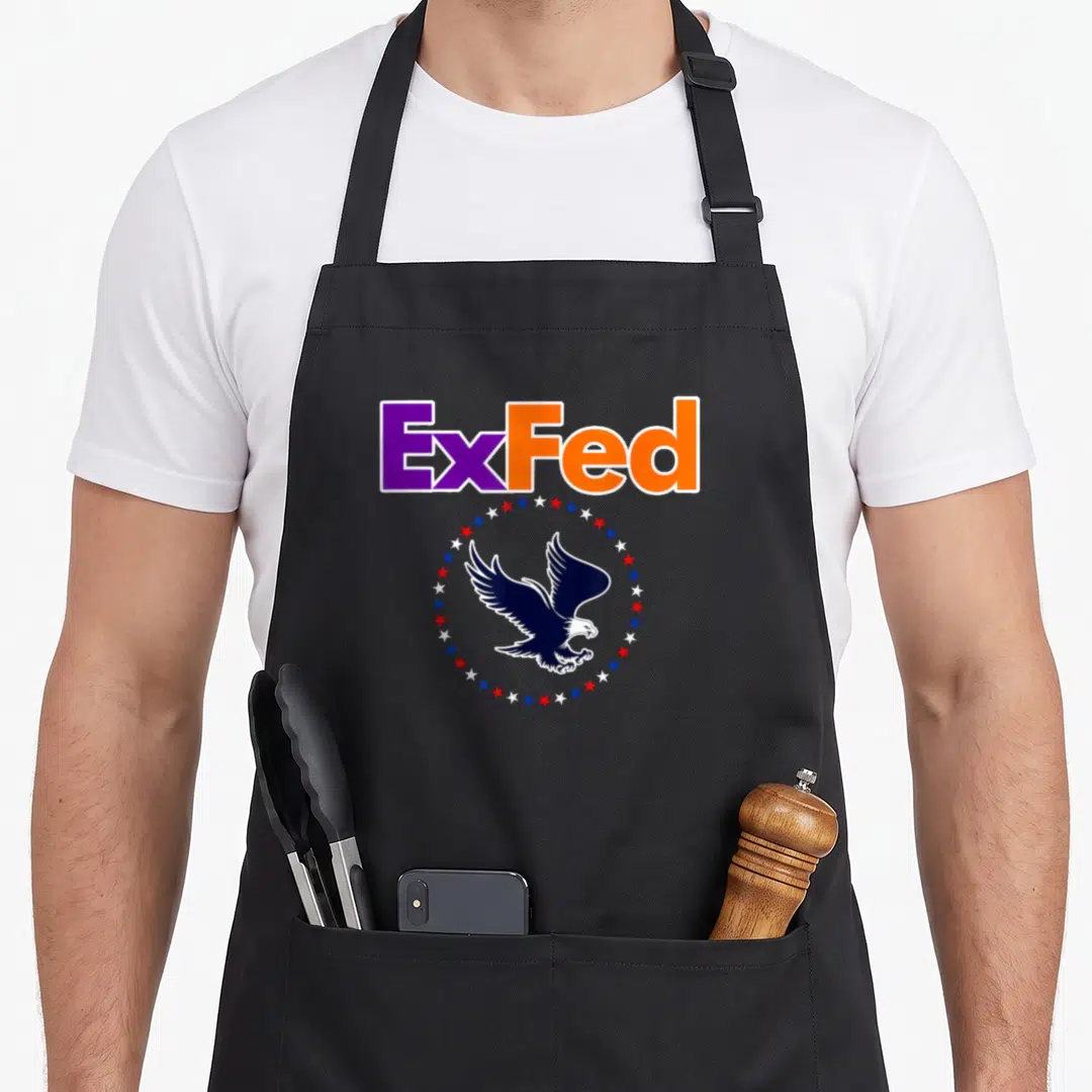 Government retired it apron - ExFed text above a navy eagle inside a circle of red white and blue stars — shown on a black cotton canvas apron against a white background