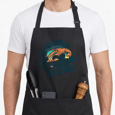 Sunshine cajun aprons - Retro orange crawfish over striped blue orange yellow teal circle with script text — shown on a black cotton canvas apron against a white background