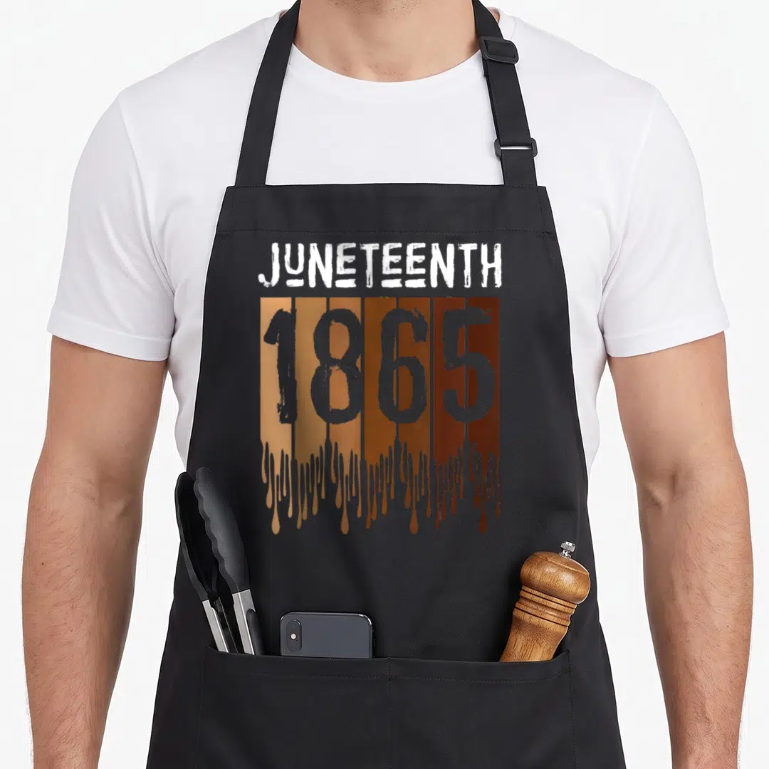 Juneteenth celebration apron - JUNETEENTH 1865 text over five dripping brown paint bands on grey background — shown on a black cotton canvas apron against a white background