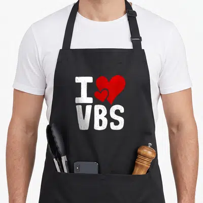 Vacation bible christian apron - White I and VBS text with two overlapping red hearts in a distressed style — shown on a black cotton canvas apron against a white background