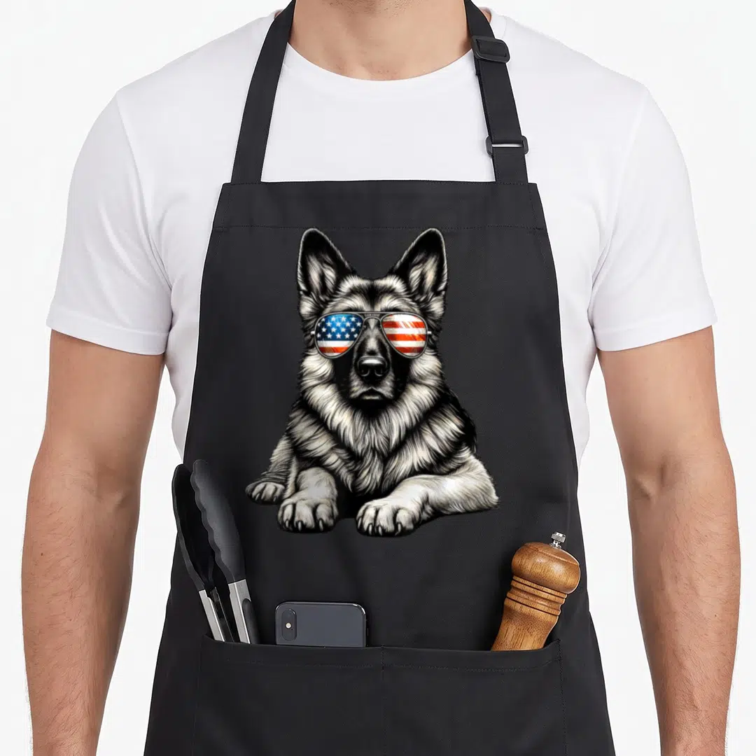 Sunglass american flag apron - Realistic German Shepherd wearing sunglasses with red white and blue flag reflections — shown on a black cotton canvas apron against a white background