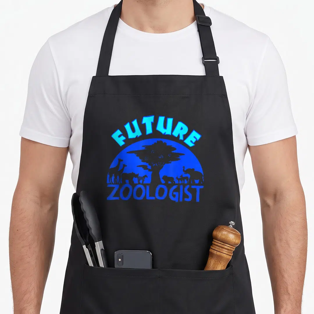 Zoologist student aprons - Blue Future Zoologist text over animal silhouettes and tree in semi-circle — shown on a black cotton canvas apron against a white background