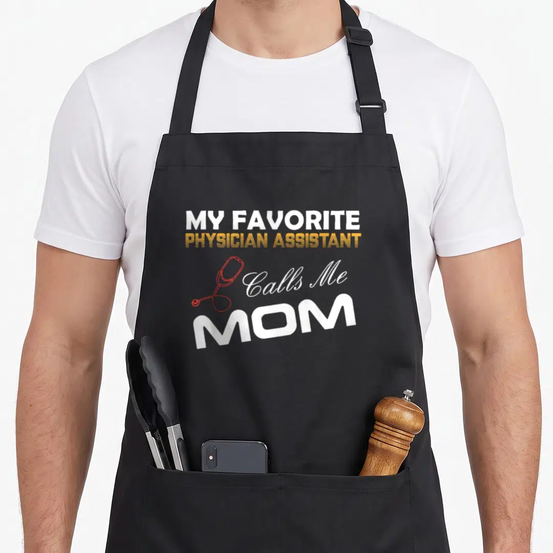 Call physician apron - White and orange text reading My Favorite Physician Assistant Calls Me Mom with a red — shown on a black cotton canvas apron against a white background