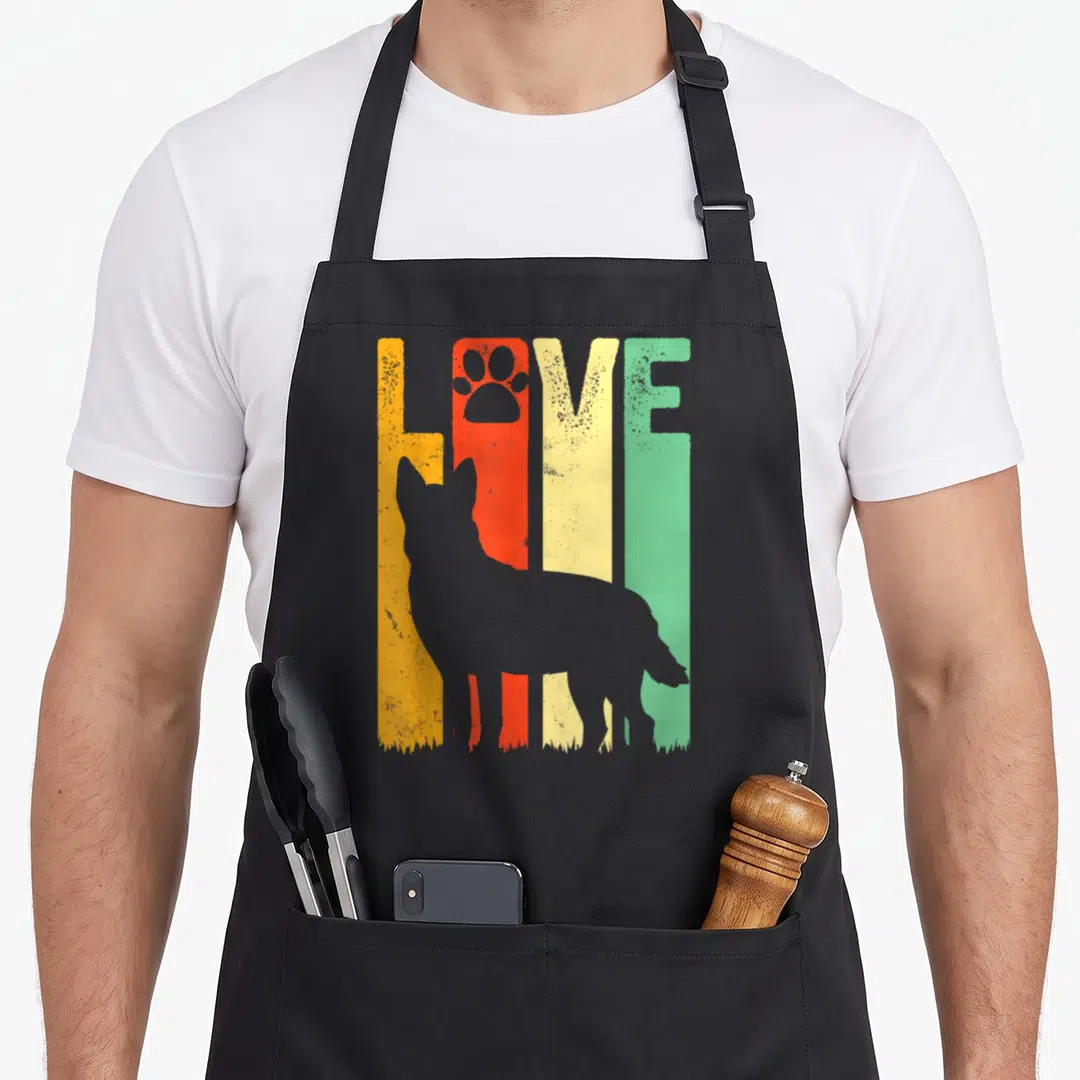 Blue pet dog kitchen apron - Grey dog silhouette over orange red yellow and green vertical bars spelling LOVE — shown on a black cotton canvas apron against a white background