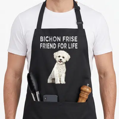 Frise friend dog apron - Realistic white Bichon Frise sitting below BICHON FRISE FRIEND FOR LIFE text on grey background — shown on a black cotton canvas apron against a white background