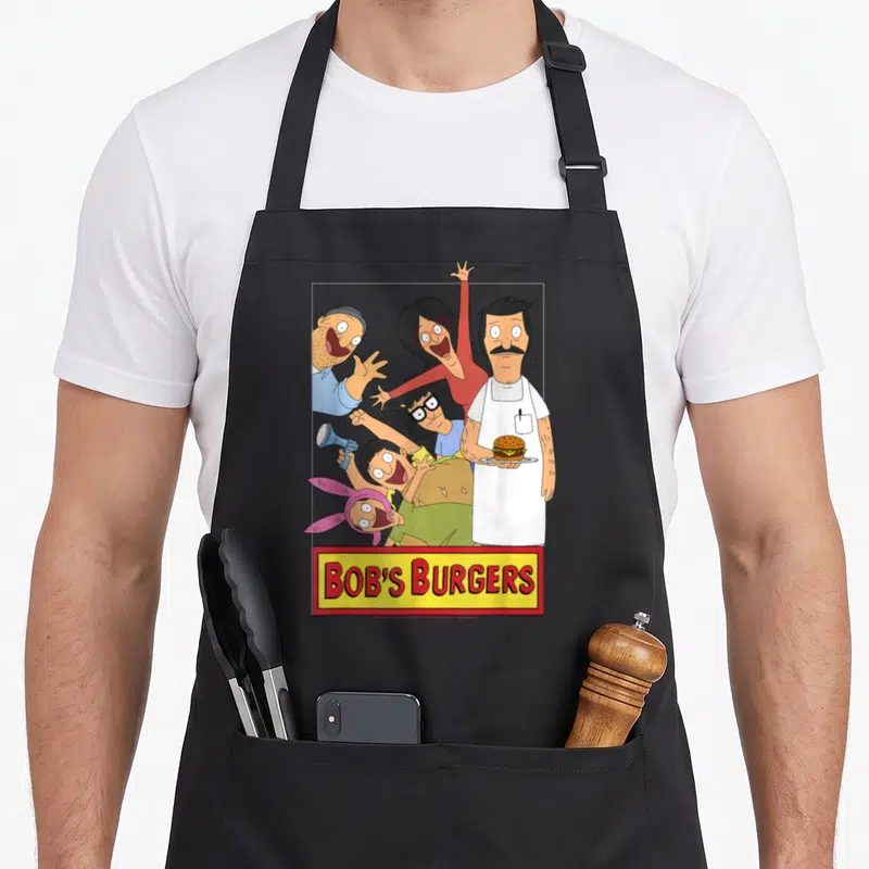 Family bobs burger apron - Group of five cartoon characters above yellow sign with red BOB'S BURGERS text — shown on a black cotton canvas apron against a white background