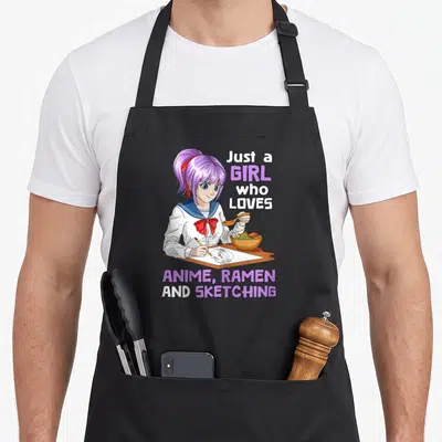 Anime ramen sketching japan apron - Purple hair girl eating ramen and sketching with text Just a Girl Who Loves Anime — shown on a black cotton canvas apron against a white background