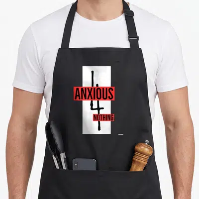 Vintage anxious apron - Black cross on white with red bars reading ANXIOUS NOTHING — shown on a black cotton canvas apron against a white background