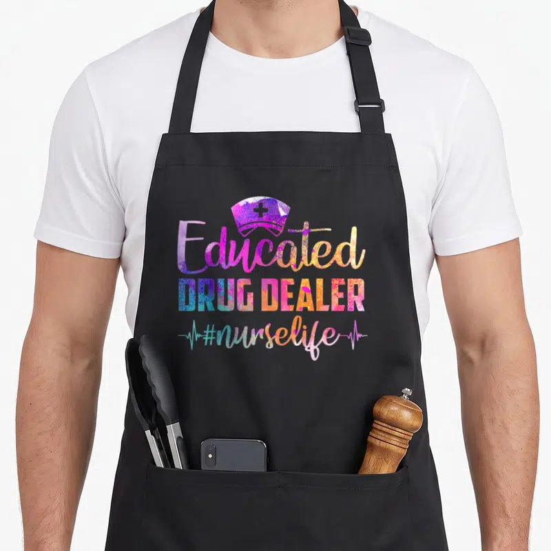 Dealer nurse apron - Colorful nurse hat above 'Educated DRUG DEALER' text and heartbeat line — shown on a black cotton canvas apron against a white background