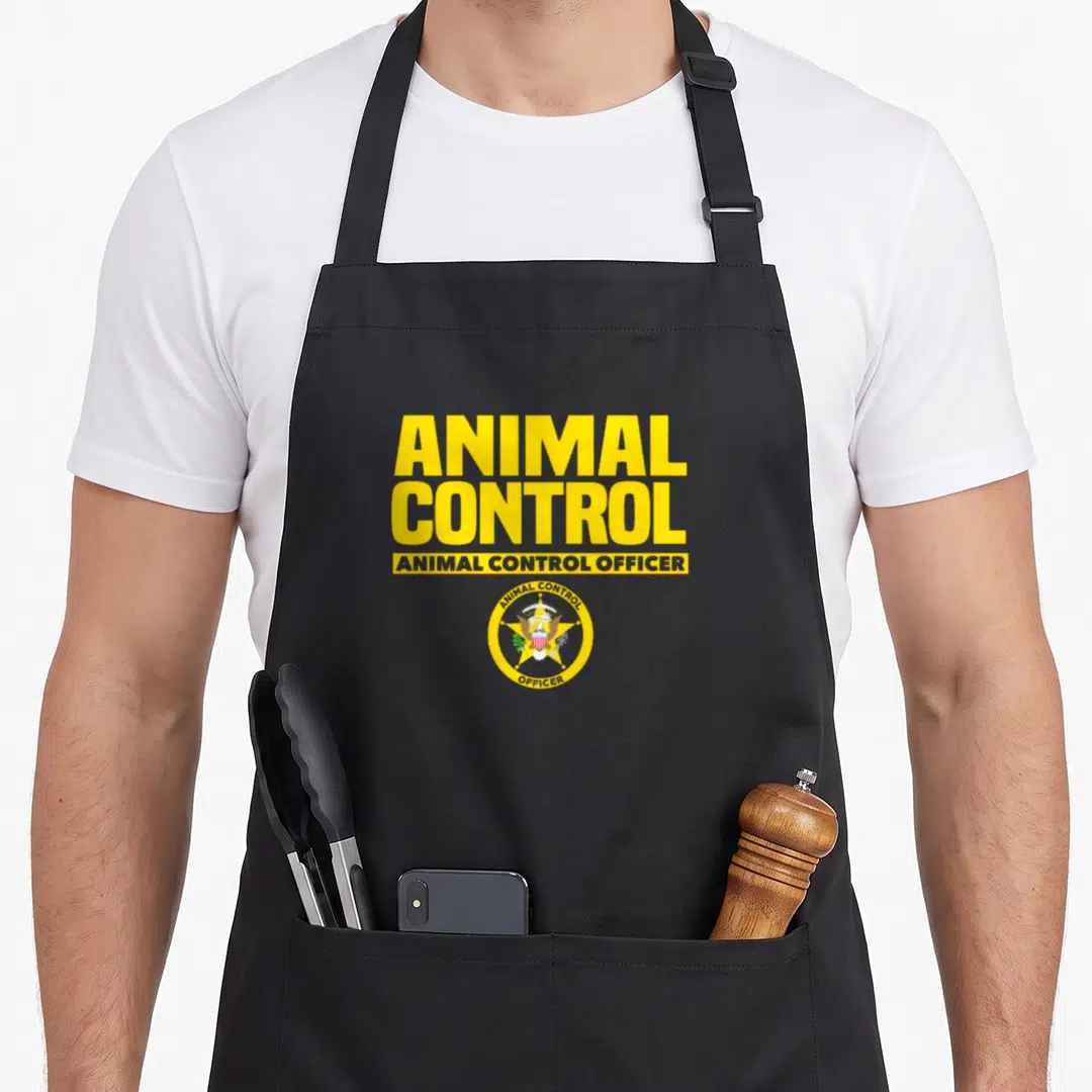 Control safety apron - Yellow ANIMAL CONTROL text and circular officer badge seal on grey fabric — shown on a black cotton canvas apron against a white background