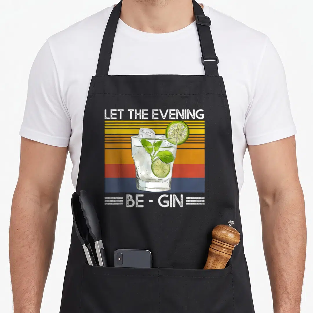 Evening cocktail apron - Retro gin cocktail glass over yellow orange red blue stripes with white text — shown on a black cotton canvas apron against a white background