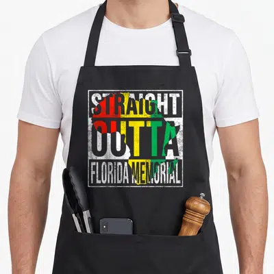 Memorial florida apron - Distressed map of Africa with red yellow green bands and white STRAIGHT OUTTA FLORIDA MEMORIAL — shown on a black cotton canvas apron against a white background