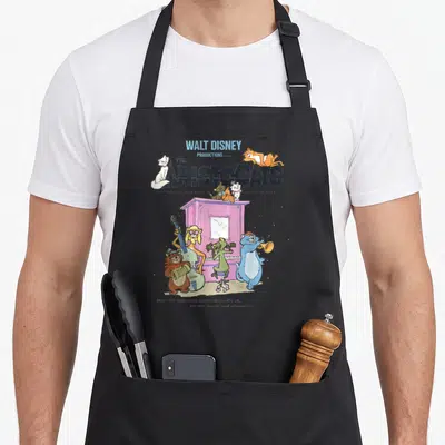Aristocat piano apron - Vintage Aristocats title with cats playing instruments around a purple piano — shown on a black cotton canvas apron against a white background