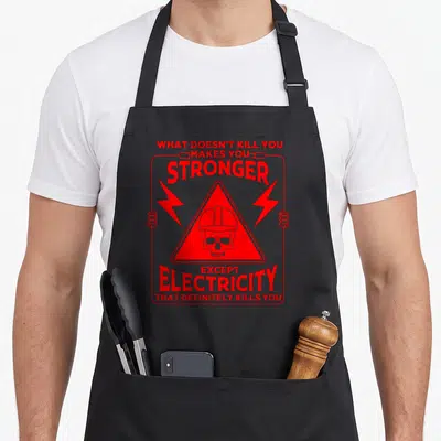 Kill electrician apron - Red skull in warning triangle with lightning bolts and electrician safety quote — shown on a black cotton canvas apron against a white background
