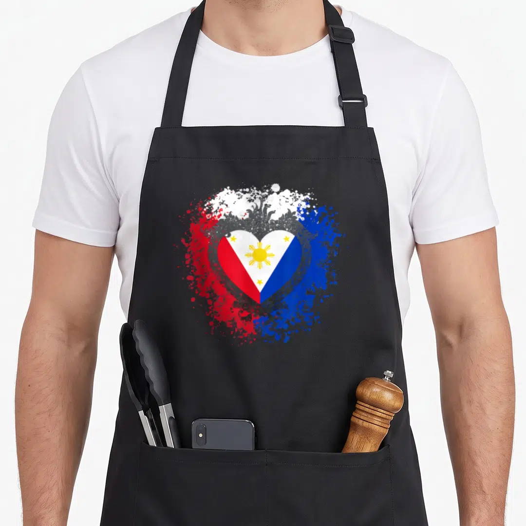 Filipino philippine pride apron - Heart shaped Philippine flag with distressed splatter art in red white blue and yellow — shown on a black cotton canvas apron against a white background