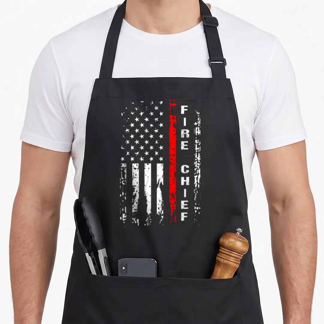 Chief firefighter apron - Distressed USA flag and vertical FIRE CHIEF text separated by a red stripe — shown on a black cotton canvas apron against a white background