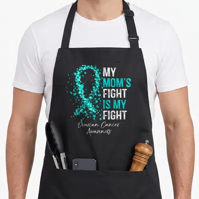 Fight cancer awareness apron - Teal heart ribbon with MY MOM'S FIGHT IS MY FIGHT text and Ovarian Cancer Awareness — shown on a black cotton canvas apron against a white background